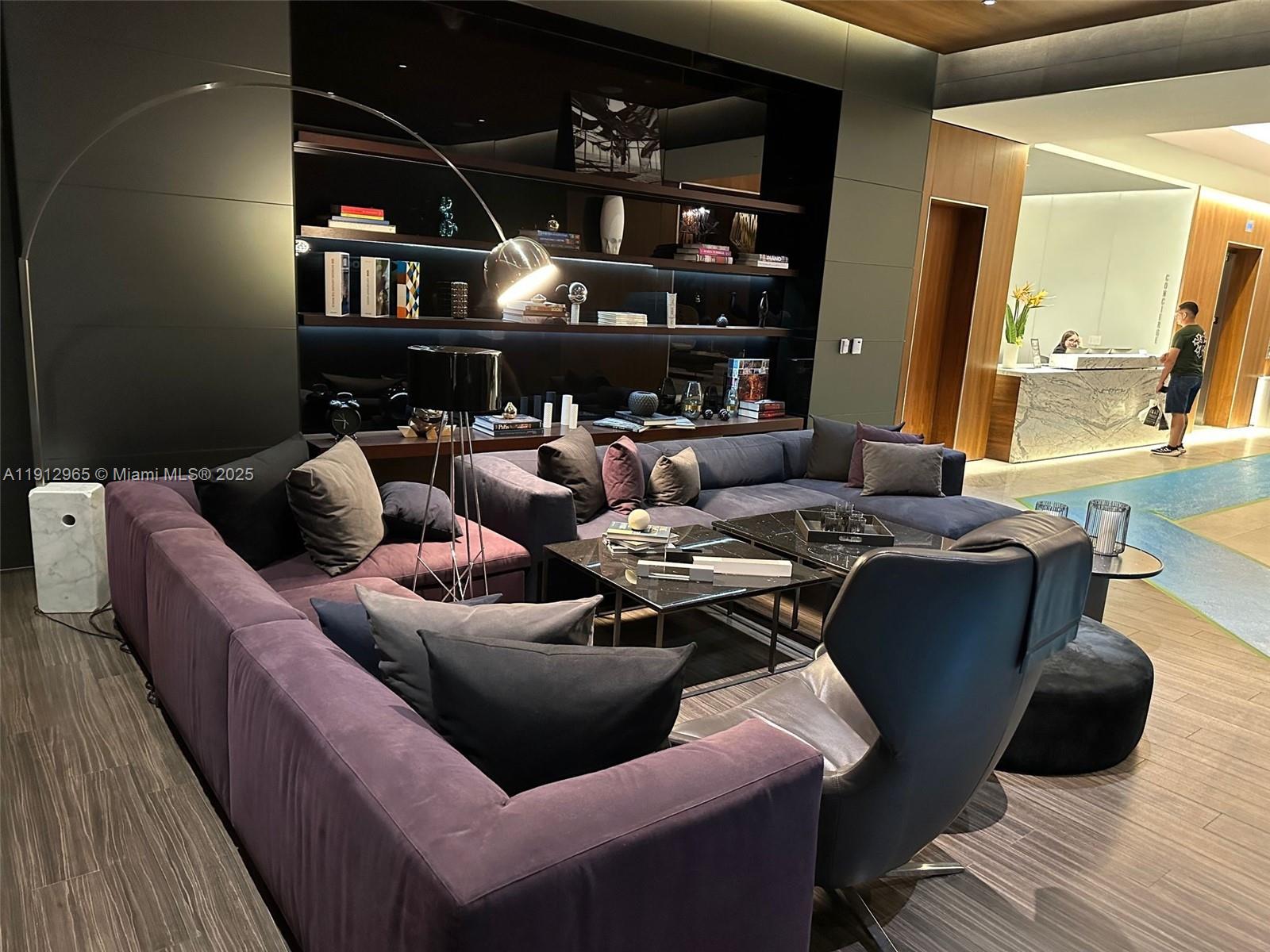 68 Southeast 6th Street, Unit 2205 Miami, FL 33131 - Photo 6 of 28 a living room with furniture and a mirror