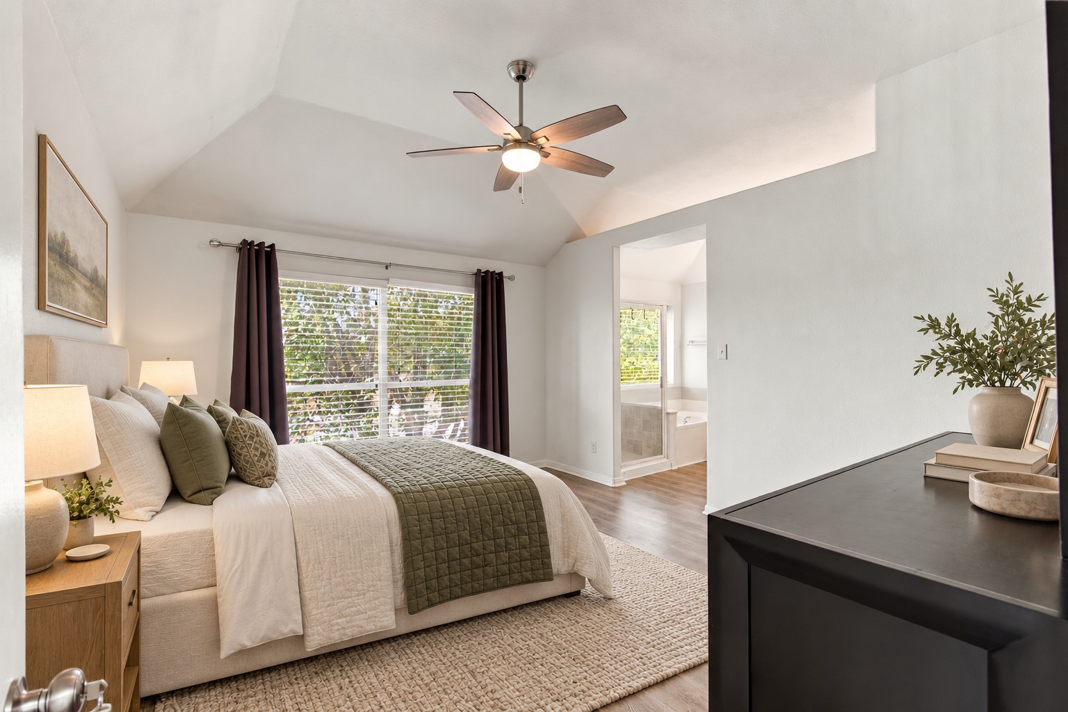 910 Point Run Drive Pflugerville, TX 78660 - Photo 6 of 39 Vaulted ceilings and warm wood floors elevate this tranquil bedroom suite with attached bath.