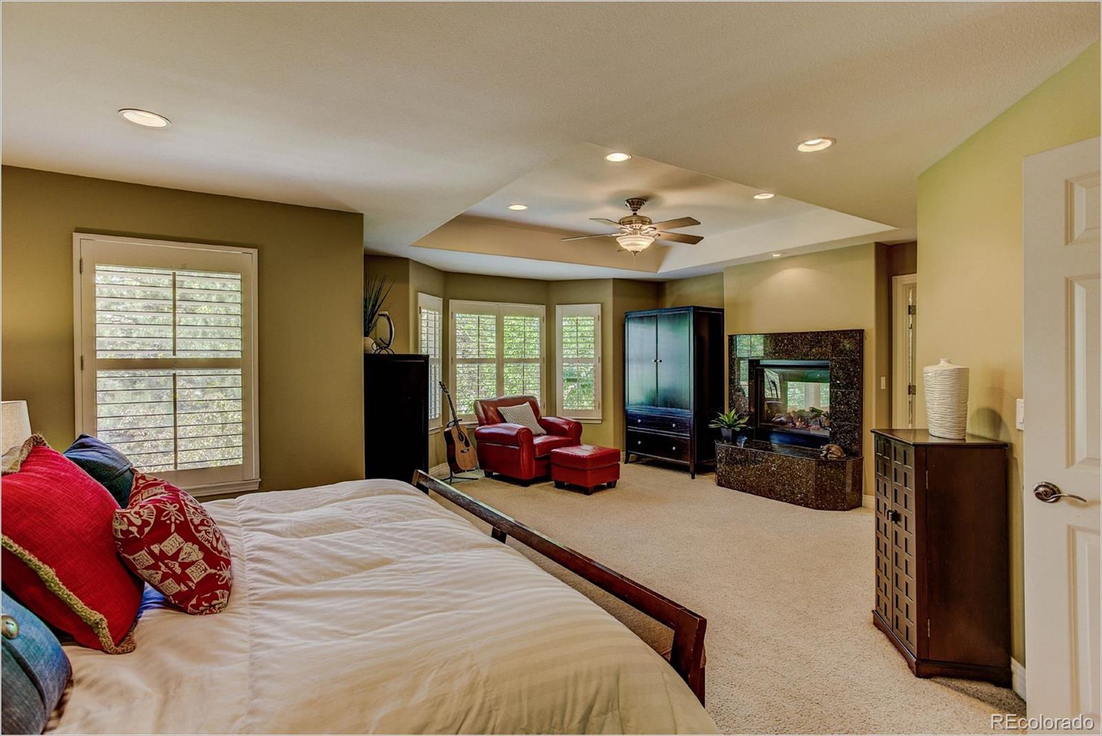 9425 South Shadow Hill Circle Lone Tree, CO 80124 - Photo 17 of 35 a bedroom with bed and large windows
