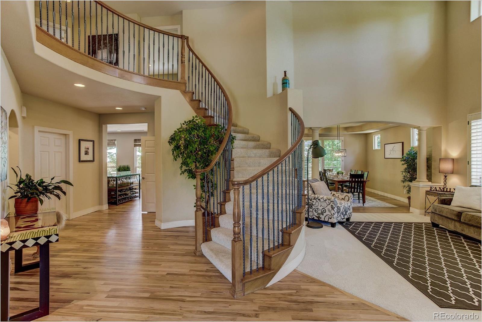 9425 South Shadow Hill Circle Lone Tree, CO 80124 - Photo 3 of 35 a view of a livingroom with wooden floor and furniture