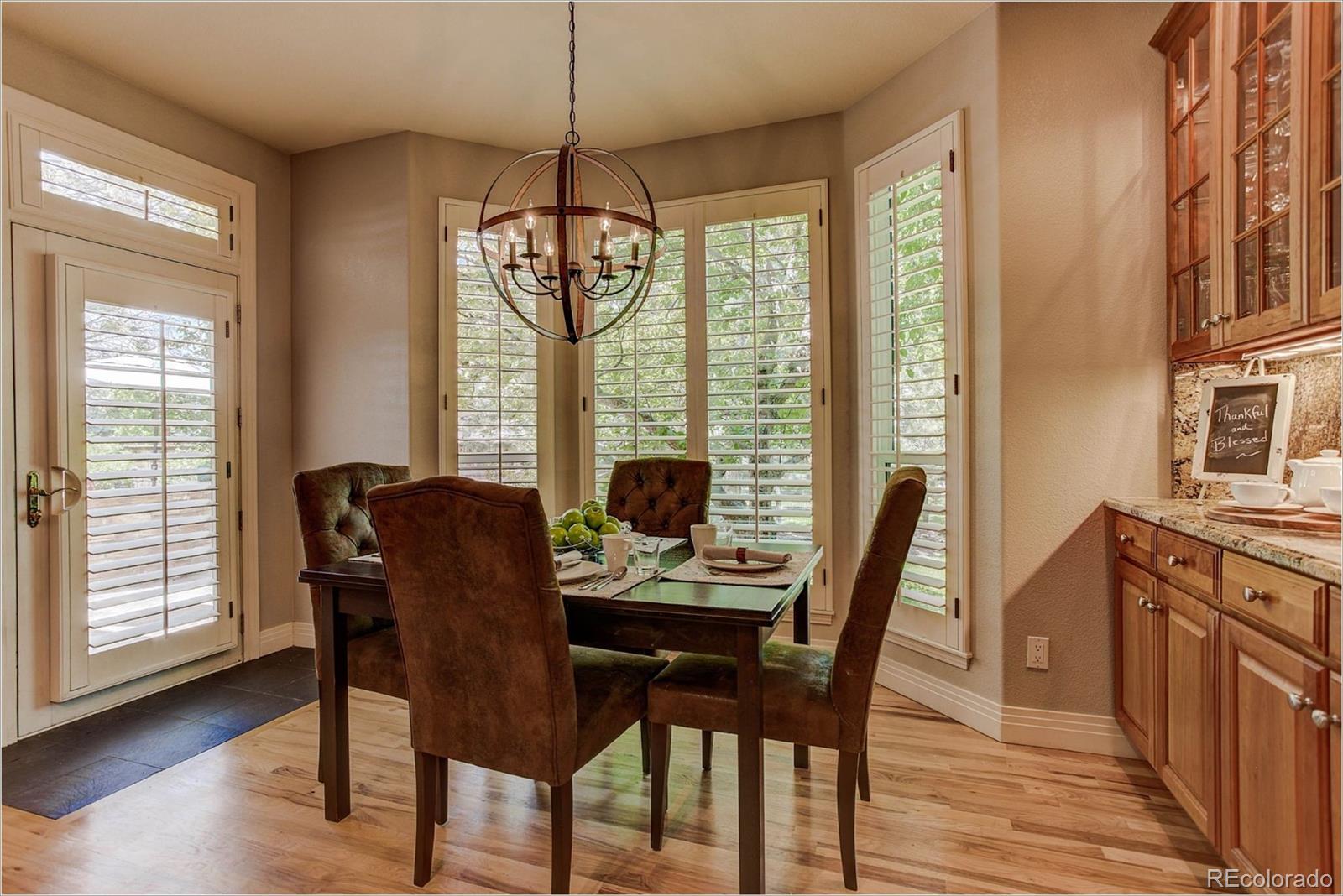 9425 South Shadow Hill Circle Lone Tree, CO 80124 - Photo 9 of 35 a view of a dining room with furniture window and wooden floor
