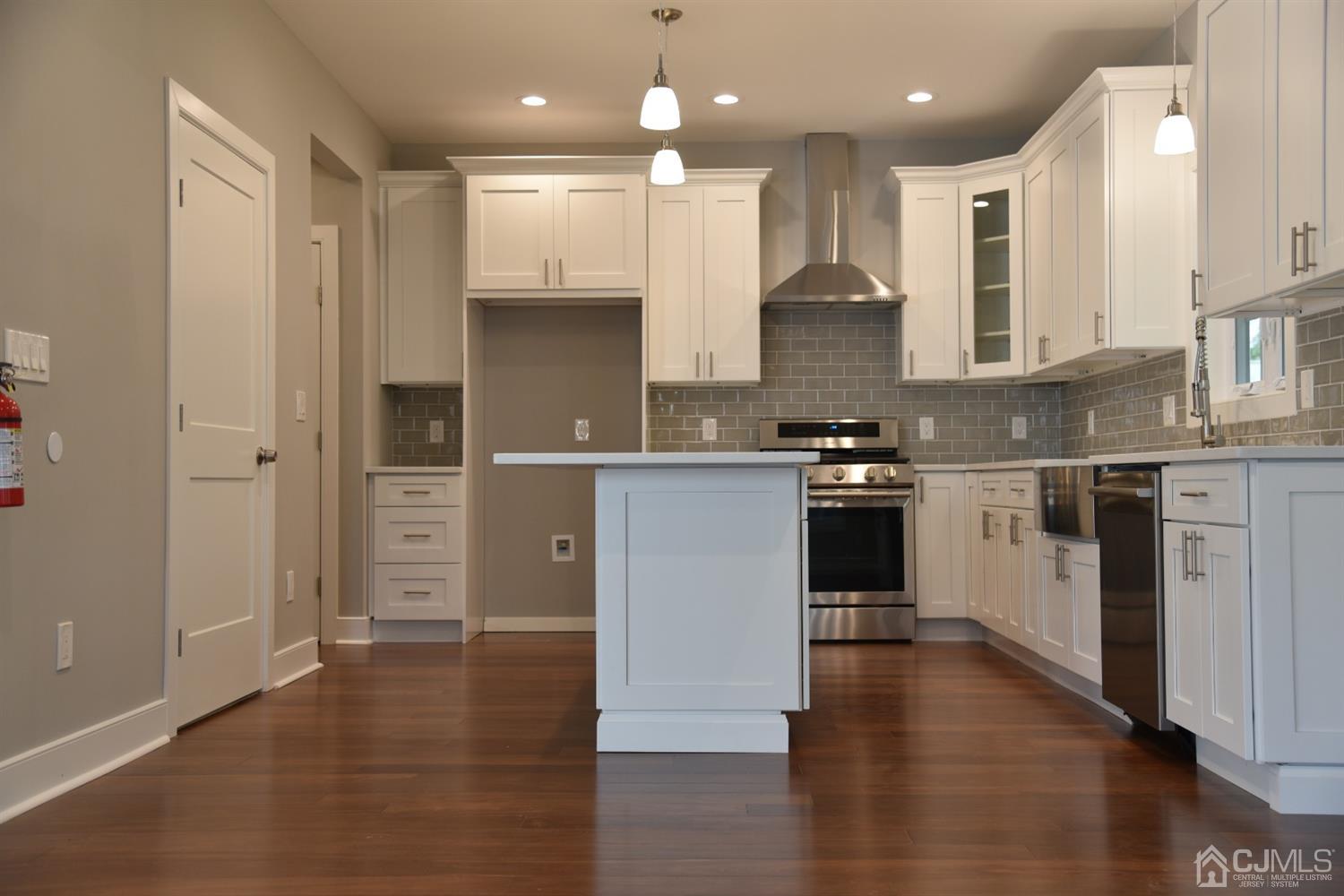 18 Dobson Road Edison, NJ 08817 - Photo 5 of 24 a kitchen with stainless steel appliances granite countertop a stove a sink and a refrigerator