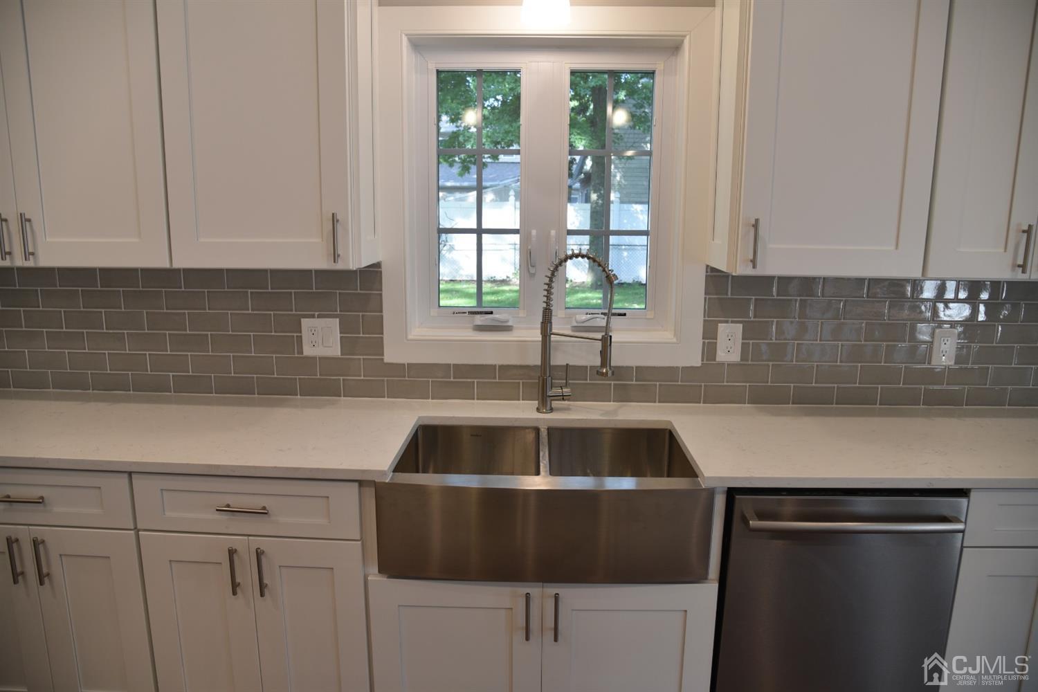 18 Dobson Road Edison, NJ 08817 - Photo 6 of 24 a kitchen with a sink and cabinets