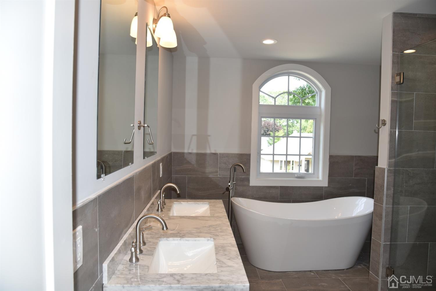18 Dobson Road Edison, NJ 08817 - Photo 7 of 24 a bathroom with a bathtub and a window