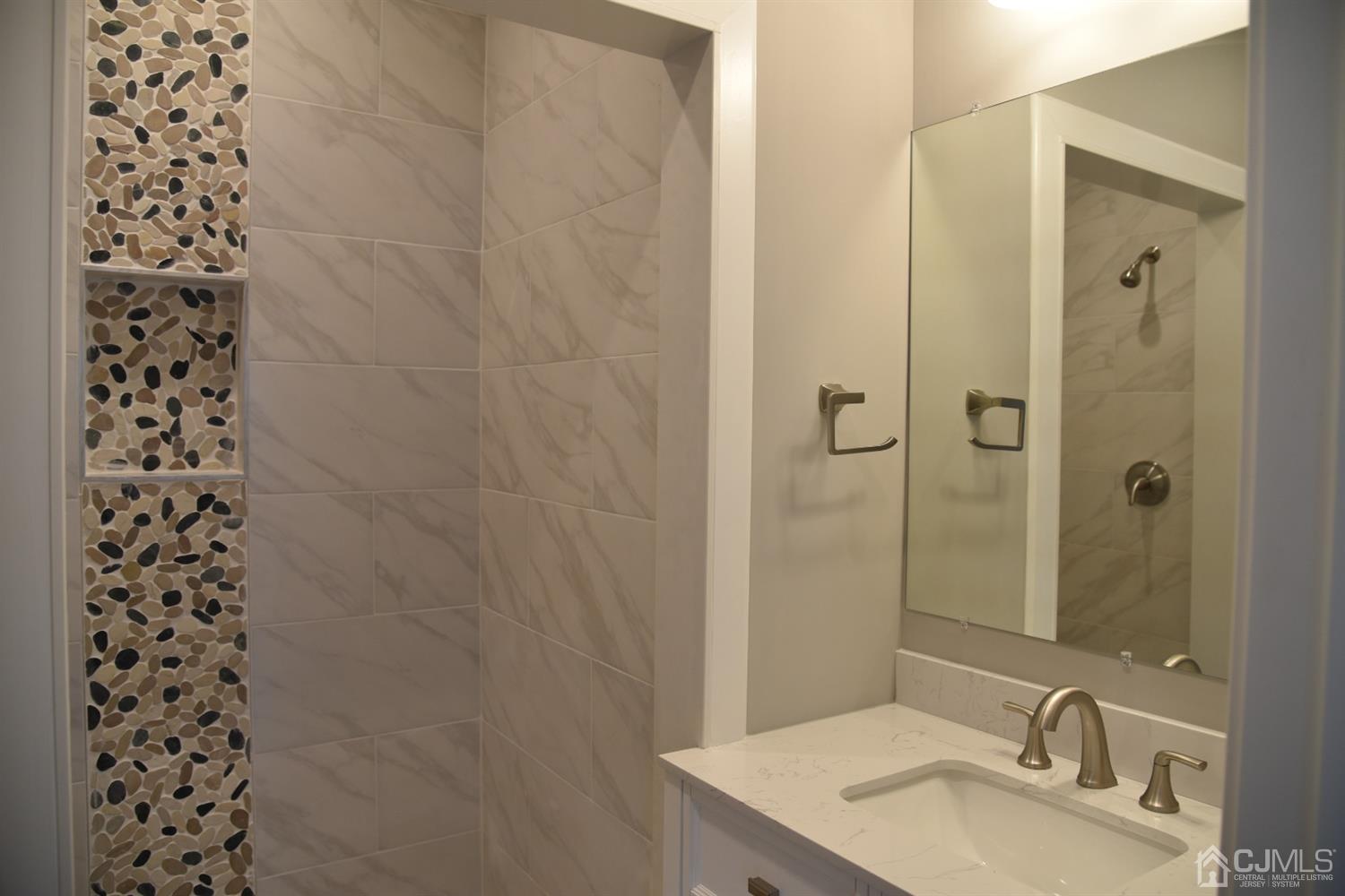 18 Dobson Road Edison, NJ 08817 - Photo 9 of 24 a bathroom with a sink a toilet and shower