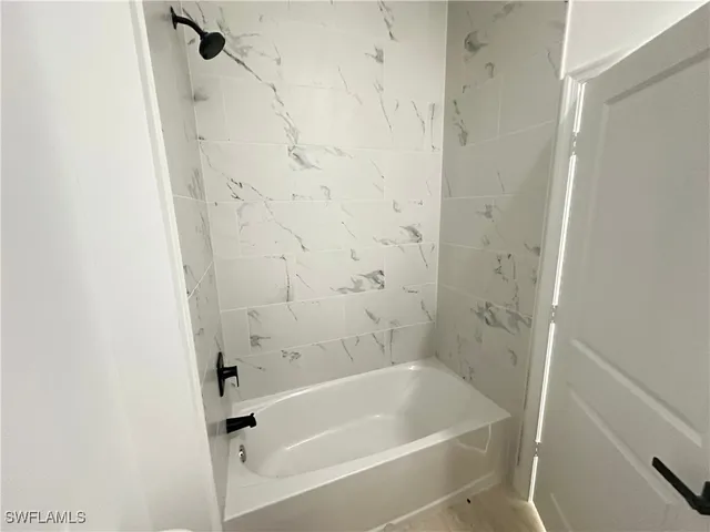 a bath tub sitting next to a white sink and vanity
