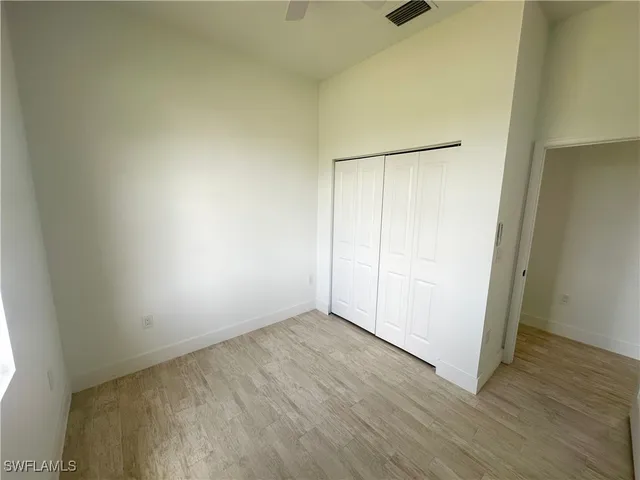 an empty room with wooden floor