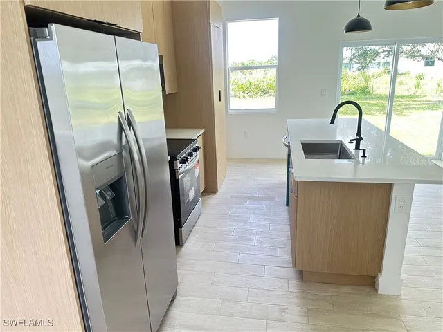 a kitchen with refrigerator a washer and dryer