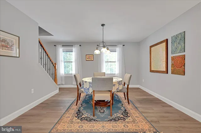 a kitchen with kitchen island wooden cabinets and refrigerator