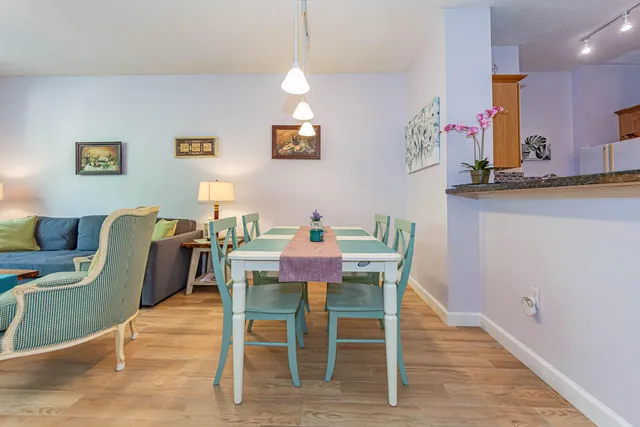 a dining room with furniture and wooden floor