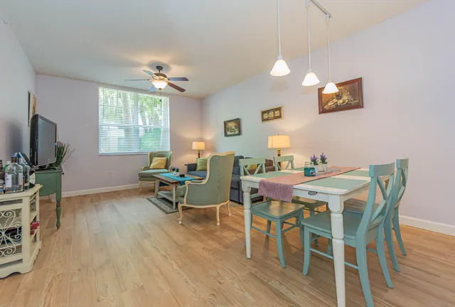 a view of a dining room with furniture window and wooden floor