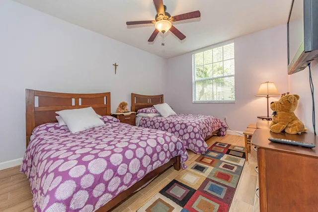 a bedroom with beds and a chandelier