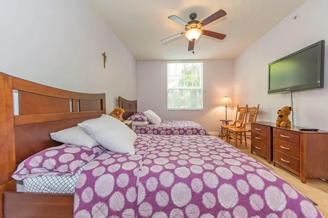 a bedroom with a bed and a flat screen tv