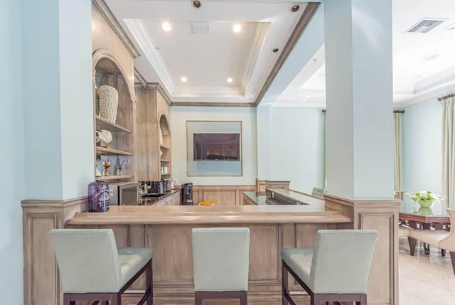 a living room with furniture and floor to ceiling windows
