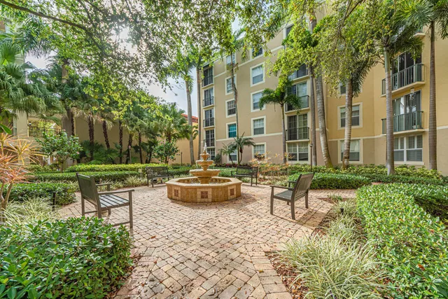 a view of a patio with couches table and chairs and potted plants