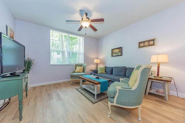 a living room with furniture a window and a flat screen tv
