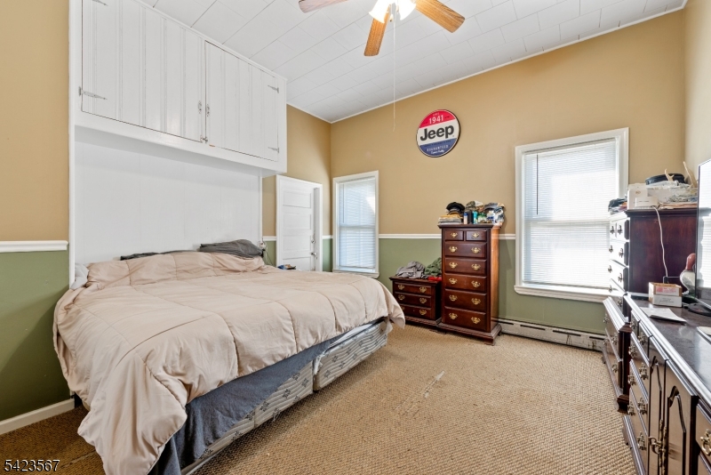 2 Prospect Street Mount Arlington, NJ 07856 - Photo 8 of 24 a bedroom with a bed and a chandelier