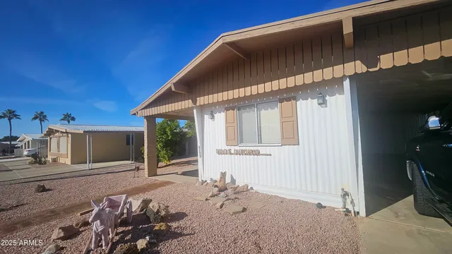 a view of a patio with table and chairs and a bed