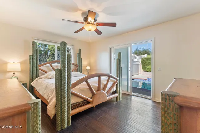 a view of a bedroom with furniture window and wooden floor