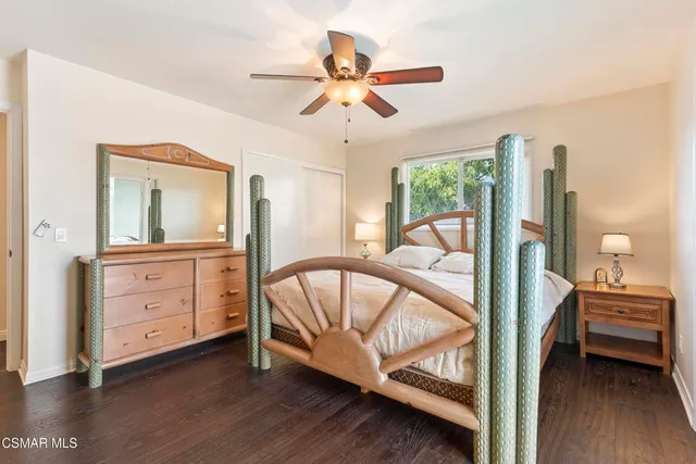 a view of a bedroom with furniture and a hardwood floor