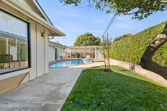a view of swimming pool with an outdoor seating