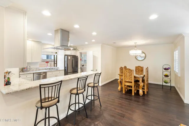 a dining room with furniture and wooden floor