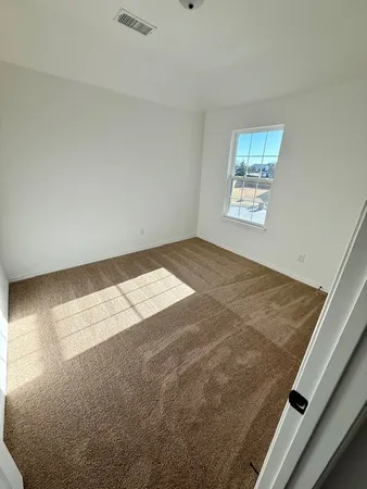 a view of wooden floor and windows in a room