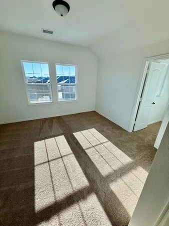 a view of an empty room with windows