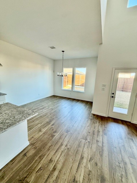 1602 Grassy Pond Road Forney, TX 75126 - Photo 7 of 21 an empty room with wooden floor and windows