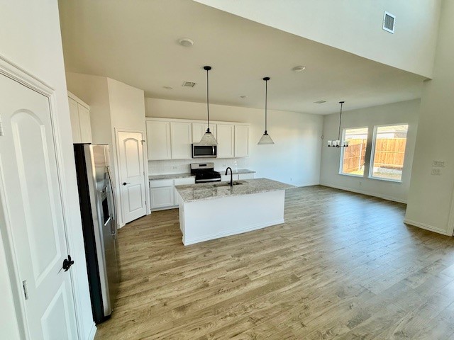 1602 Grassy Pond Road Forney, TX 75126 - Photo 8 of 21 a view of kitchen with stainless steel appliances a refrigerator and wooden floor