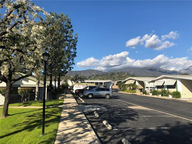 a view of city street with a car parked on the road