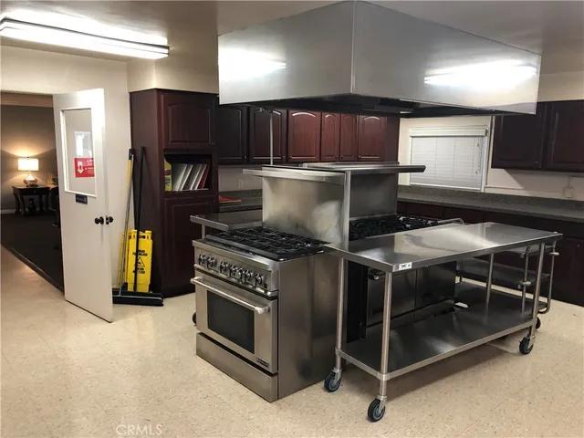 a kitchen with a stove and a refrigerator