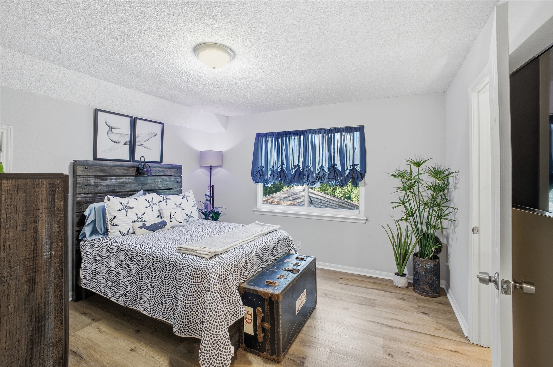 24107 Norchester Way Spring, TX 77389 - Photo 18 of 33 a bedroom with a bed and a potted plant