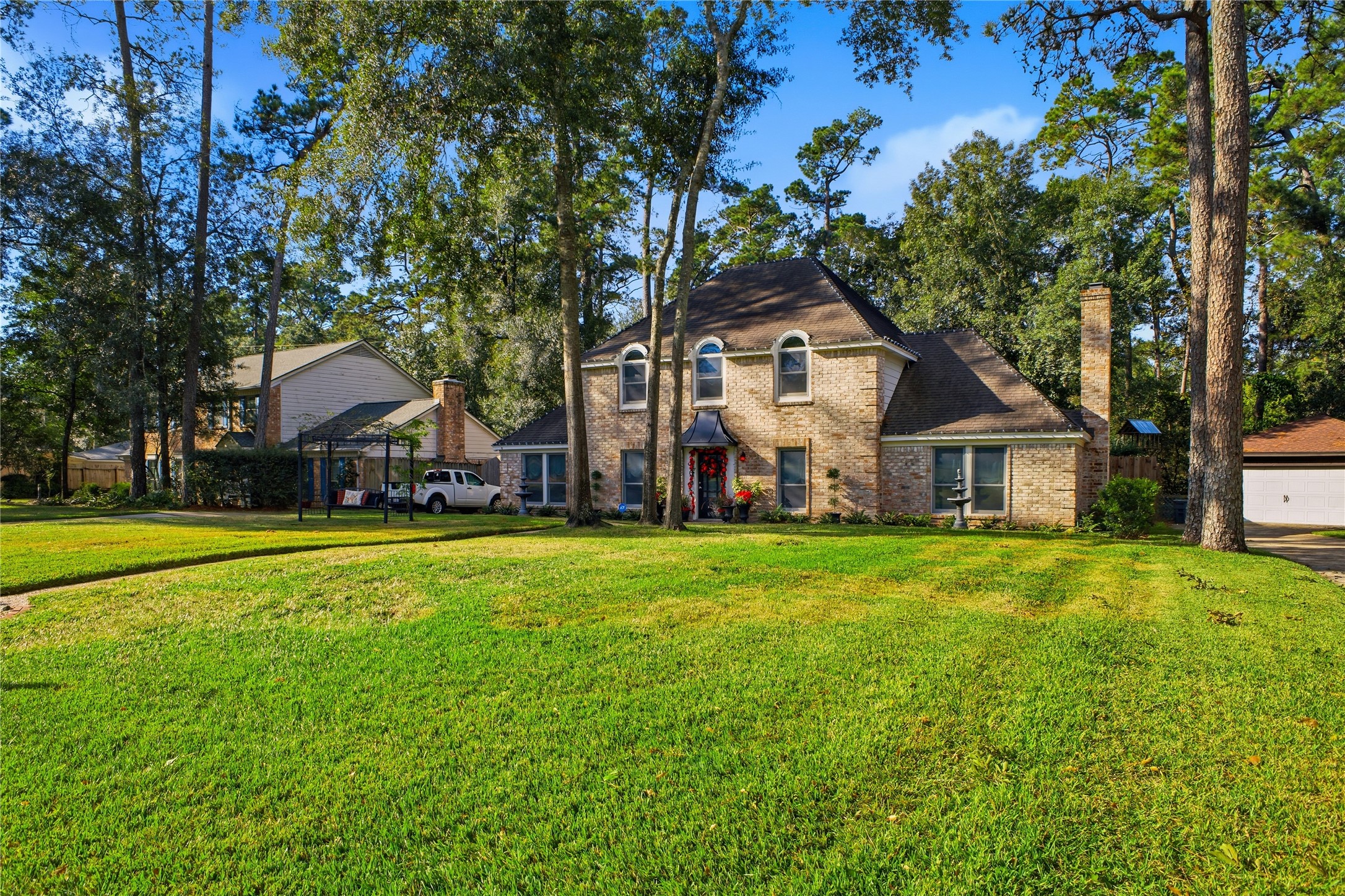 24107 Norchester Way Spring, TX 77389 - Photo 3 of 33 a front view of a house with a garden and deck