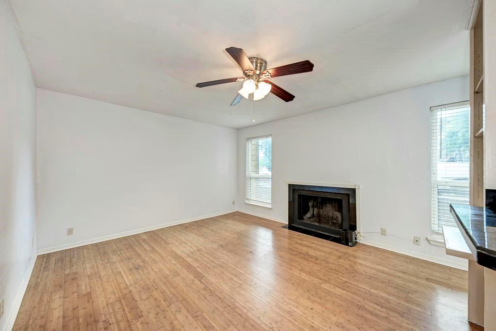 1000 West 26th Street, Unit 113 Austin, TX 78705 - Photo 2 of 10 wooden floor fireplace and windows in an empty room
