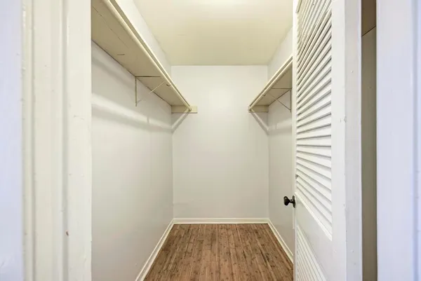 a kitchen with stainless steel appliances a stove a microwave and white cabinets