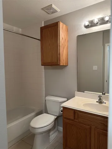 an empty room with wooden floor chandelier fan and closet