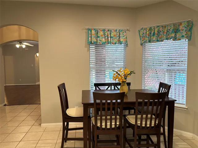 a dining room with furniture and window