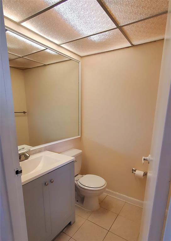 278 Flanders F, Unit F Delray Beach, FL 33484 - Photo 4 of 13 a bathroom with a granite countertop shower and a toilet