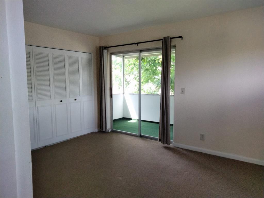 278 Flanders F, Unit F Delray Beach, FL 33484 - Photo 5 of 13 an empty room with windows