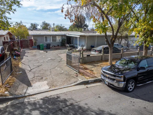 a view of a house with a backyard and sitting area