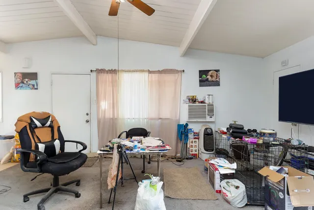 a view of a workspace with furniture and a window