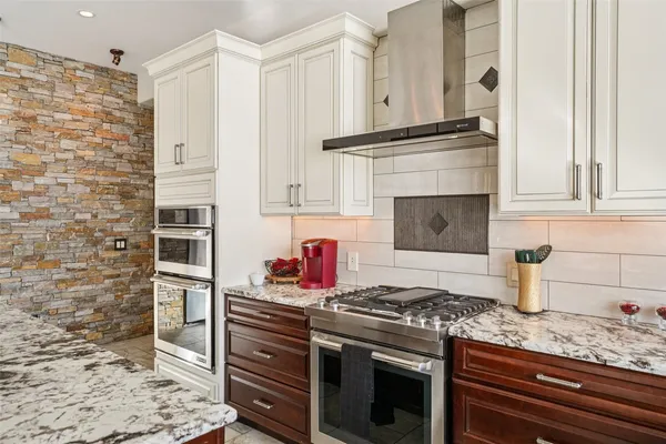 a kitchen with granite countertop cabinets stainless steel appliances and a sink