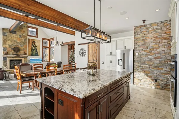 a kitchen with granite countertop a sink and a refrigerator