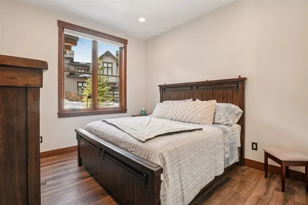 a bed sitting in a bedroom next to a window