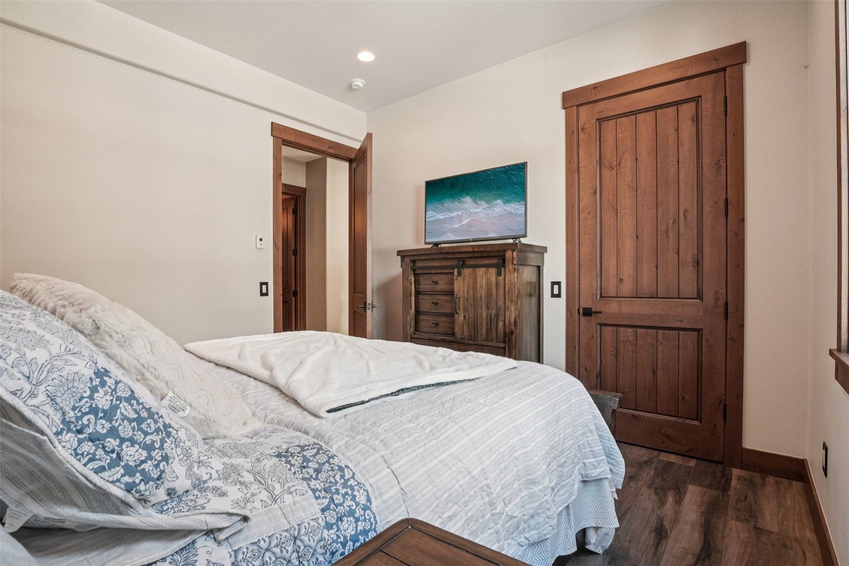 104 Talon Circle Silverthorne, CO 80498 - Photo 25 of 50 a bedroom with a bed and a flat screen tv