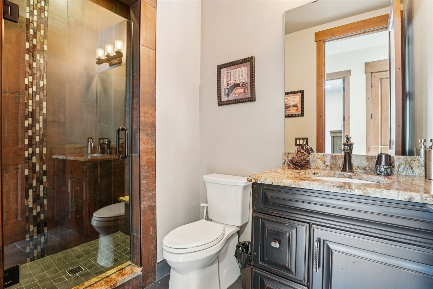 104 Talon Circle Silverthorne, CO 80498 - Photo 26 of 50 a bathroom with a granite countertop sink toilet and shower