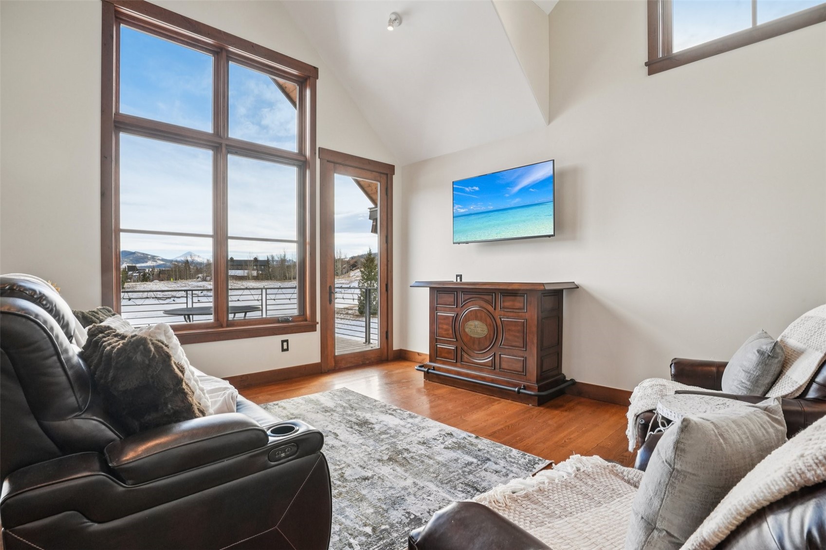104 Talon Circle Silverthorne, CO 80498 - Photo 30 of 50 a living room with furniture a floor to ceiling window and a fireplace