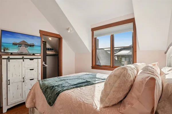 a bedroom with a bed and a window