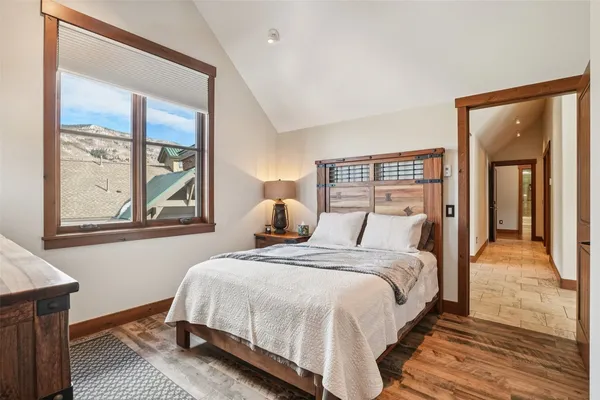 a bedroom with a bed and a large window